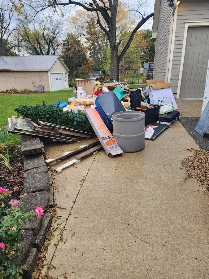 Dumpster being loaded with debris for 3 Yard Dumpster Rental in Depew